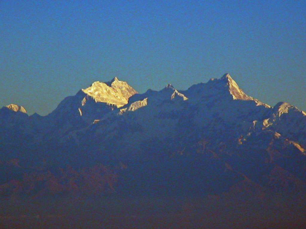 Manaslu 00 01 Manaslu From Flight To Kathmandu I watched in anticipation as the glow of the pre-dawn sun illuminated the silhouette of the Himalayan Mountains as my flight approached Kathmandu. The pilot announced that we would have to circle around Kathmandu because of low cloud cover. We had a beautiful early morning view of the sunny east face of Manaslu leading down to Ngadi Chuli (7871m, also known as Peak 29) and to the right Himal Chuli (7893m).